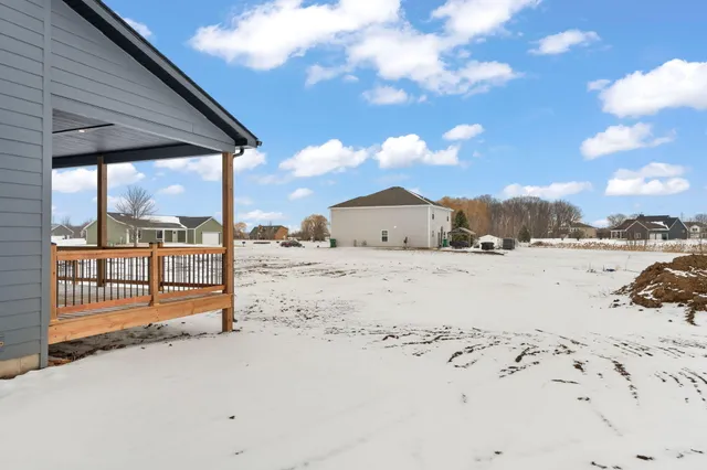 a view of a house with a wooden fence
