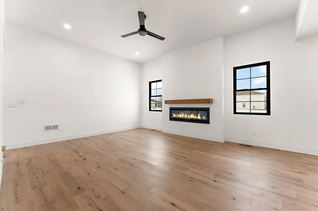 an empty room with windows and cabinet