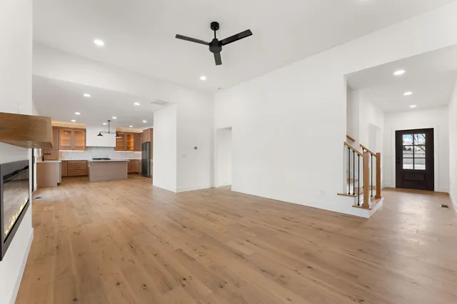 a view of a kitchen with a sink and a refrigerator