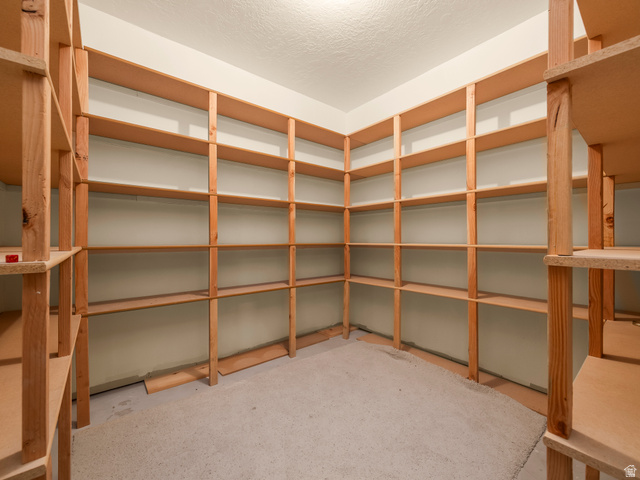 255 East 1200 North Mapleton, UT 84664 - Photo 34 of 37 Built-in wood shelving system featuring extensive storage capacity, light-toned wood construction, and a corner configuration