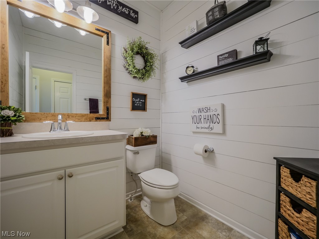 37571 Amber Way North Ridgeville, OH 44039 - Photo 14 of 35 Bathroom with tile floors, wooden walls, oversized vanity, and toilet