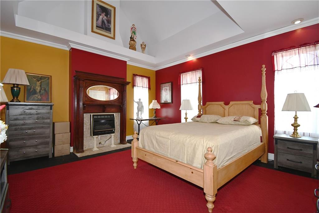 108 Locust Street Pittsburgh, PA 15210 - Photo 12 of 36 a bed sitting in a bedroom next to a window