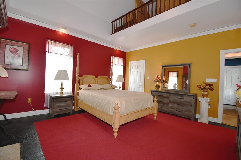 108 Locust Street Pittsburgh, PA 15210 - Photo 13 of 36 a spacious bedroom with a bed and a couch