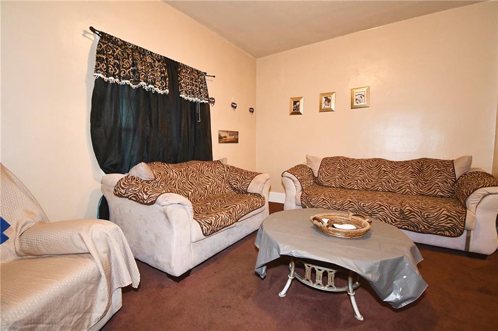 108 Locust Street Pittsburgh, PA 15210 - Photo 26 of 36 a living room with furniture and a wooden floor
