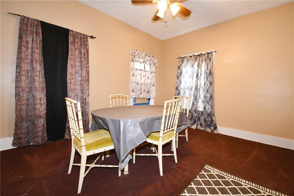 108 Locust Street Pittsburgh, PA 15210 - Photo 28 of 36 a view of a dining room with furniture wooden floor and chandelier