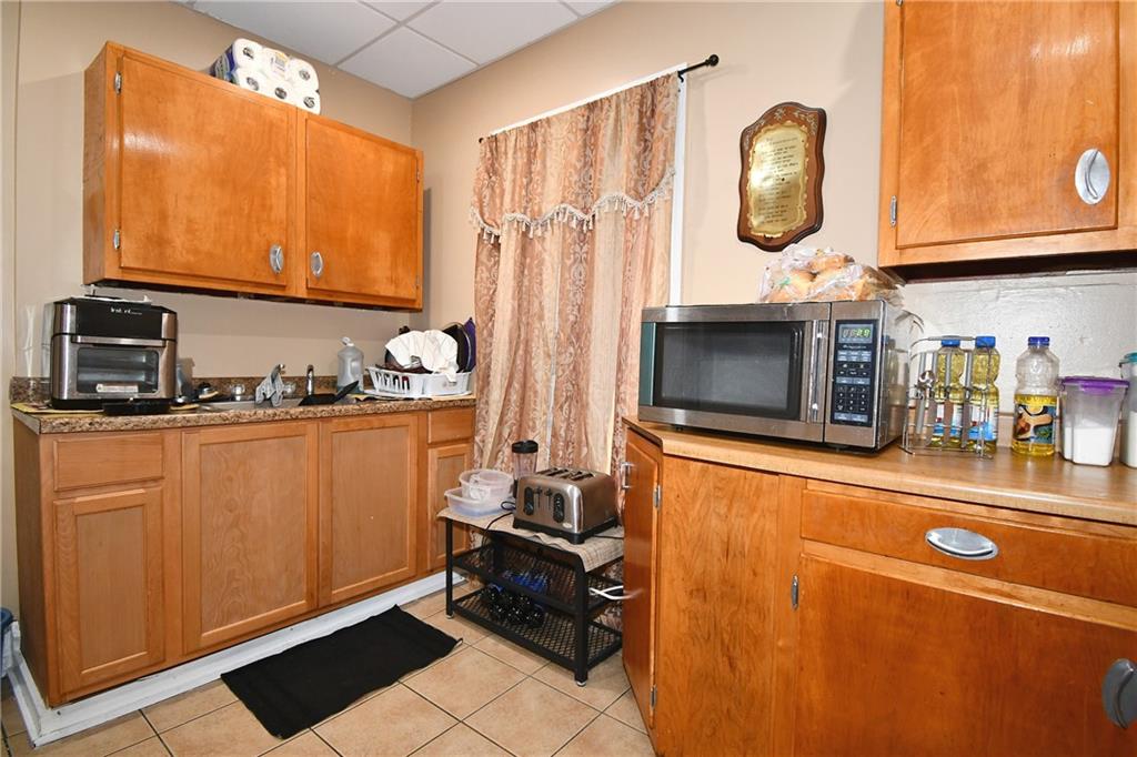 108 Locust Street Pittsburgh, PA 15210 - Photo 31 of 36 a room with stainless steel appliances granite countertop a refrigerator and a stove top oven