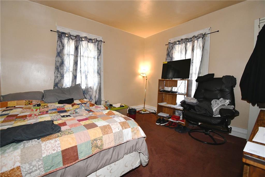108 Locust Street Pittsburgh, PA 15210 - Photo 32 of 36 a bedroom with a bed and a flat screen tv
