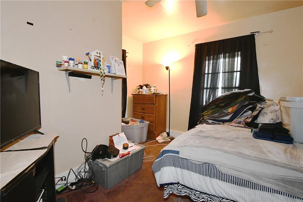 108 Locust Street Pittsburgh, PA 15210 - Photo 33 of 36 a bedroom with bed and a flat tv screen on the dresser