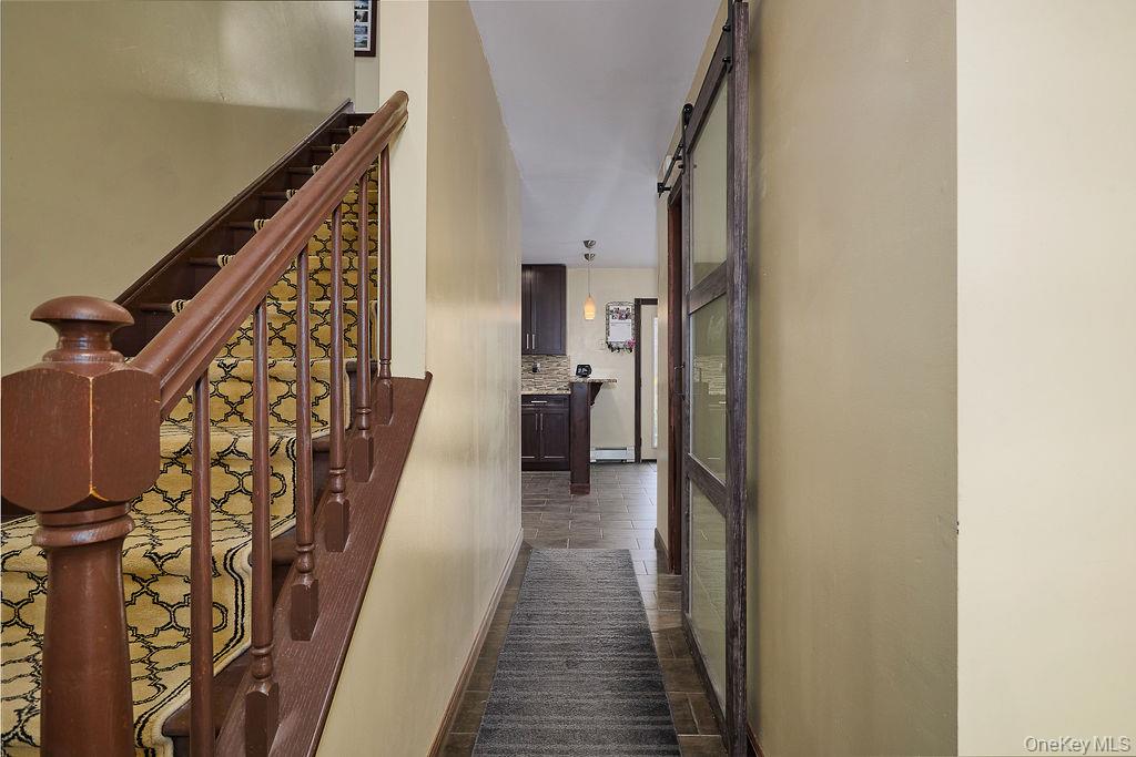 180 Ridge Drive Middletown, NY 10940 - Photo 5 of 43 View of kitchen area from entry, laundry to the left behind barn door and stairs to second level on left