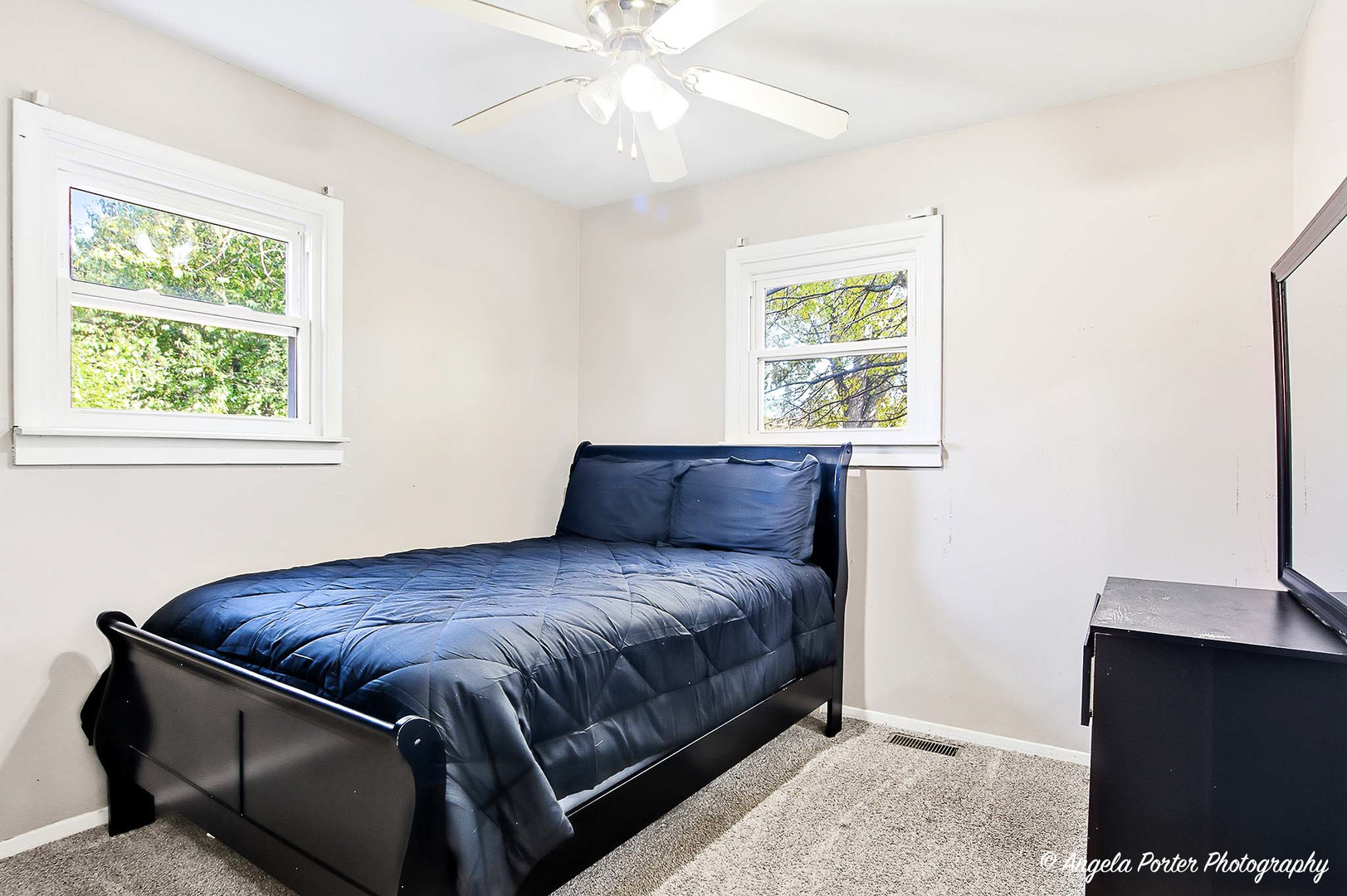 1612 Whitney Street Waukegan, IL 60087 - Photo 11 of 20 a bedroom with a bed and a flat tv screen on a dresser
