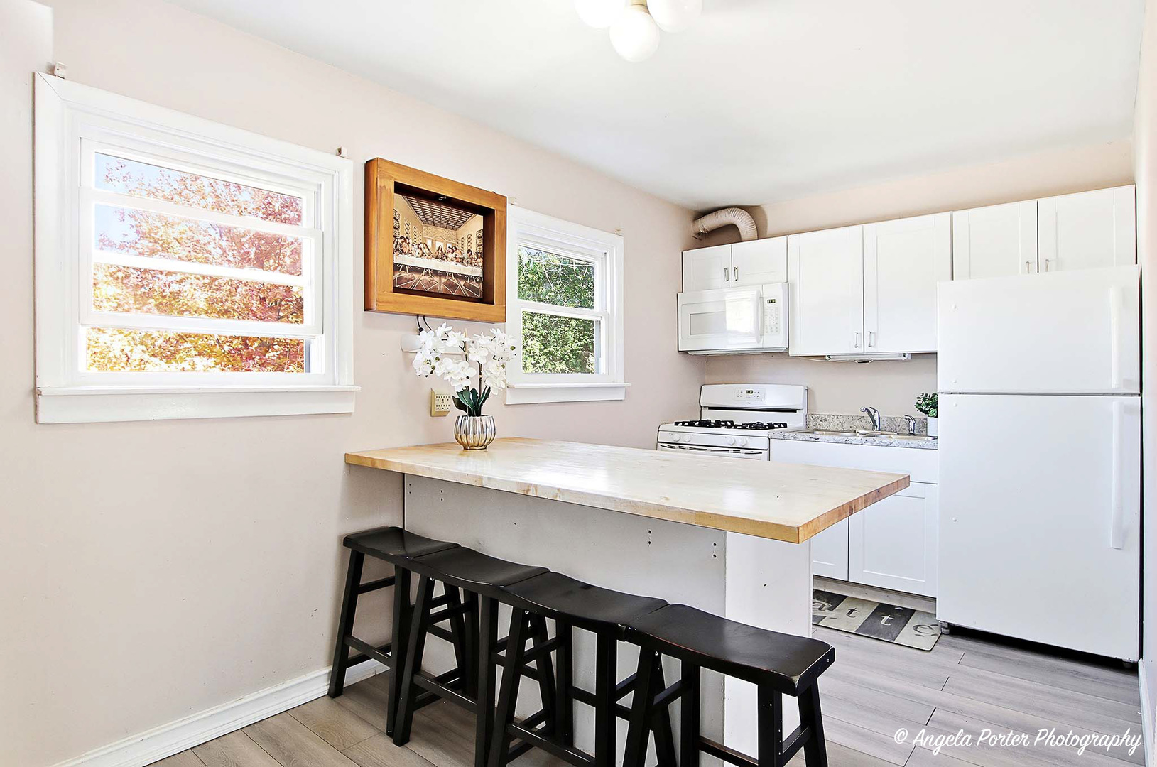 1612 Whitney Street Waukegan, IL 60087 - Photo 9 of 20 a kitchen with a table chairs a window and cabinets