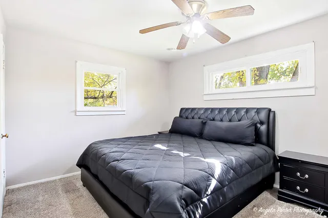 a large bed sitting in a bedroom next to a window