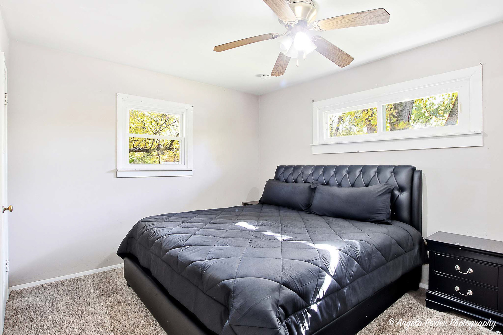 1612 Whitney Street Waukegan, IL 60087 - Photo 10 of 20 a large bed sitting in a bedroom next to a window