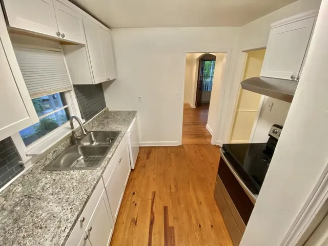 a view of a room with wooden floor