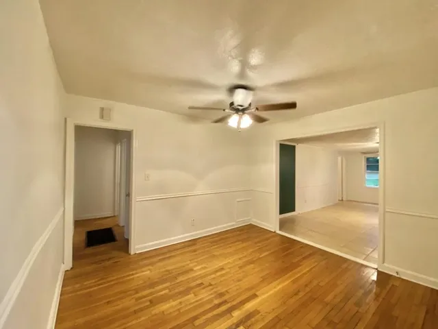 a bathroom with a sink a toilet a shower and a window