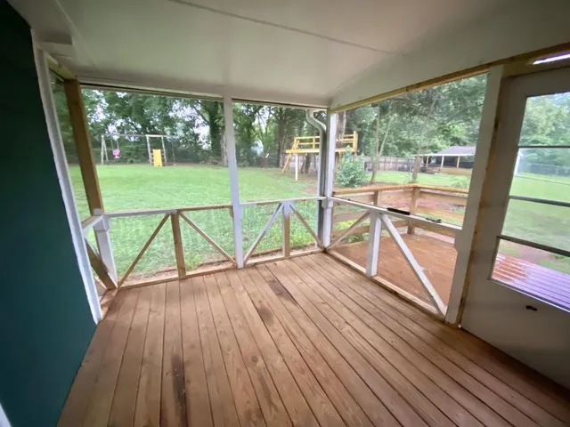 a living room with furniture two window and a fireplace