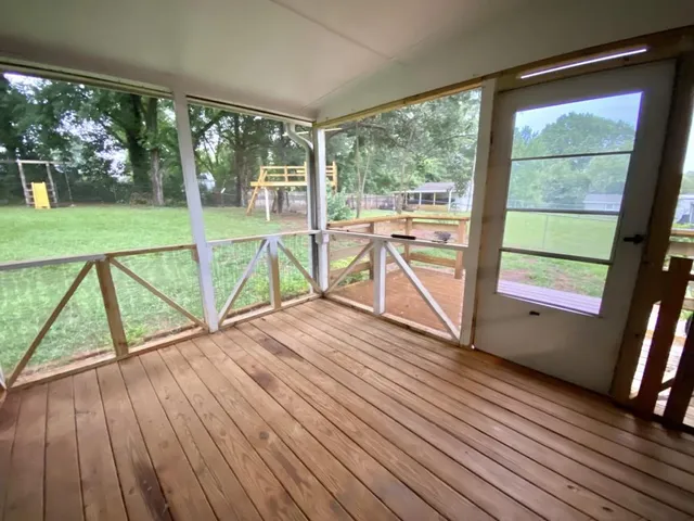 a view of a room with wooden floor and window