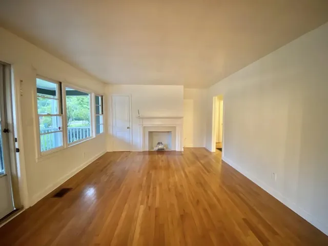 a view of a dining room with furniture wooden floor and a chandelier