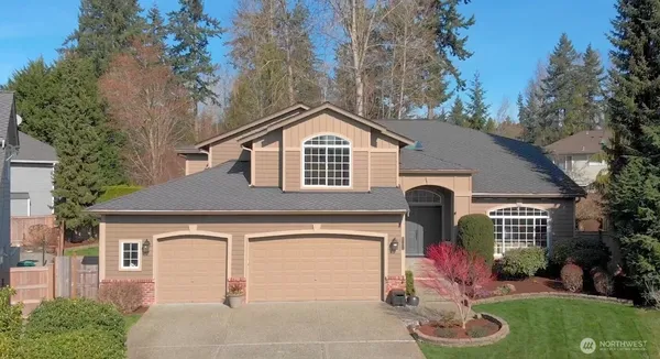 a front view of a house with a yard garage and outdoor seating