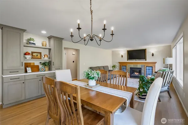 a view of a dining room with furniture a kitchen and chandelier