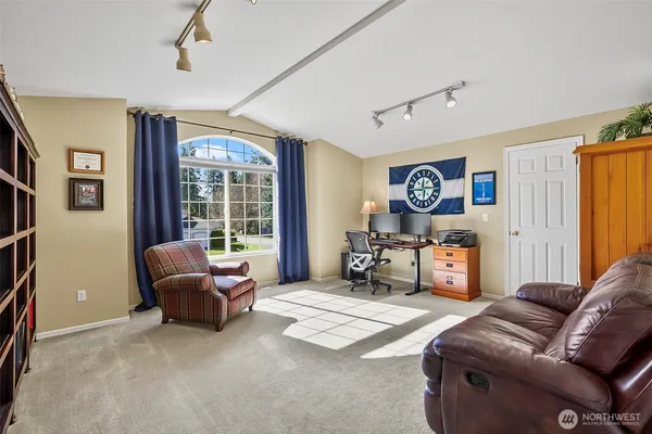 a bedroom with furniture and a large window