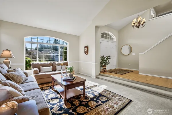 a living room with furniture rug and window