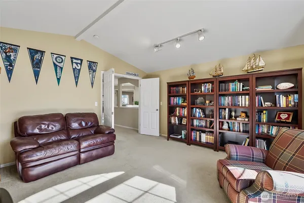 a living room with furniture cabinets and window