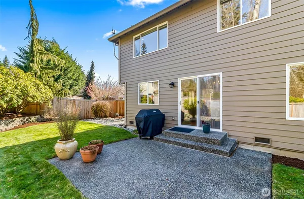a view of a backyard with chair and tables