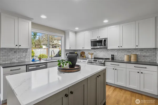 a kitchen with sink a stove and cabinets