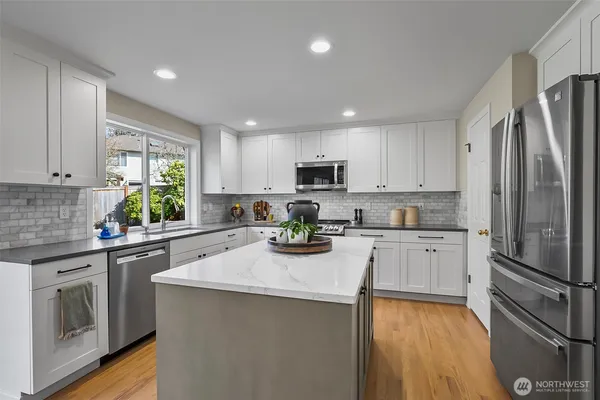 a kitchen with refrigerator a sink and cabinets