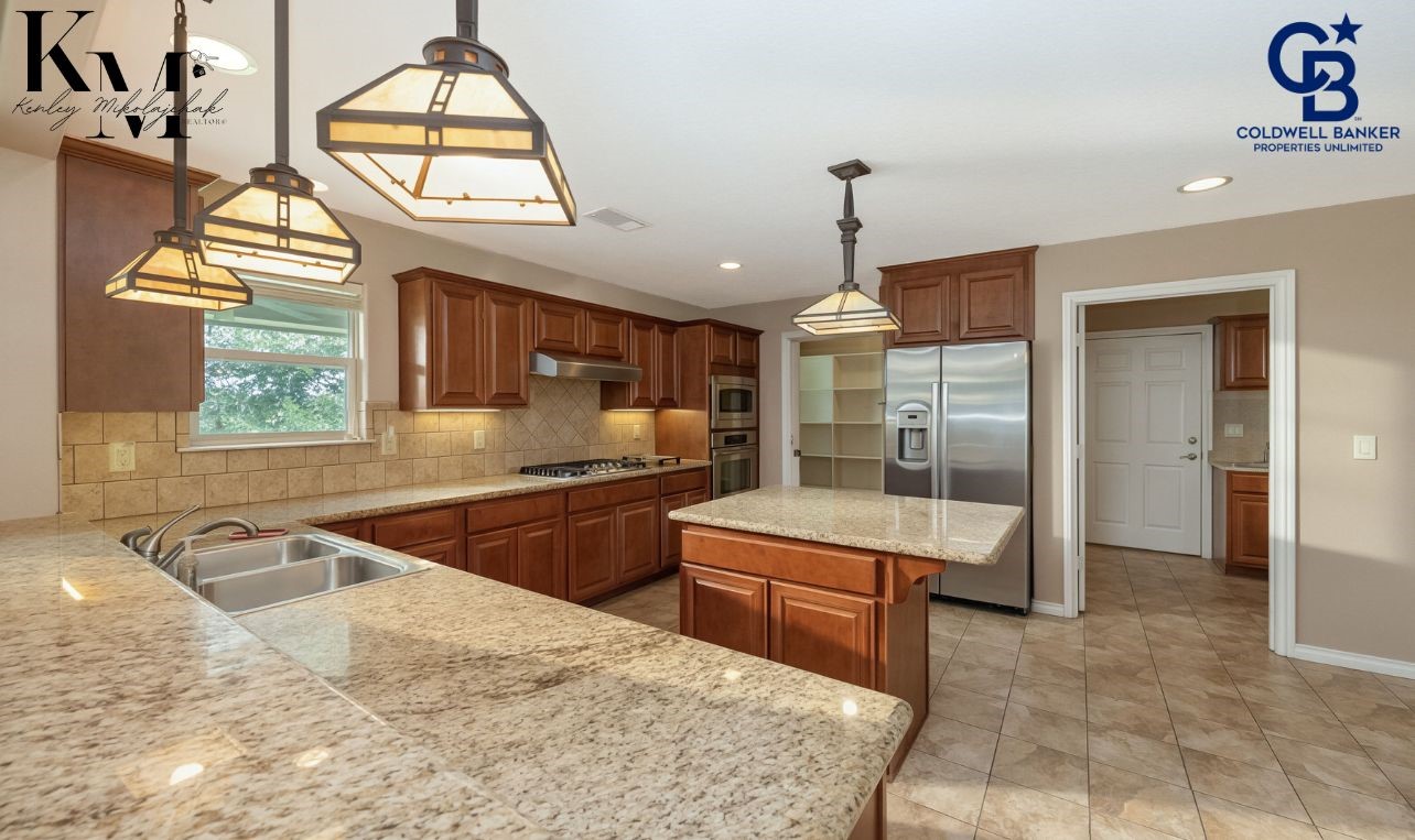 1980 Chappell Ridge Lane Brenham, TX 77833 - Photo 3 of 13 Functional kitchen featuring a gas range and ample prep space, ideal for both daily living and entertaining.