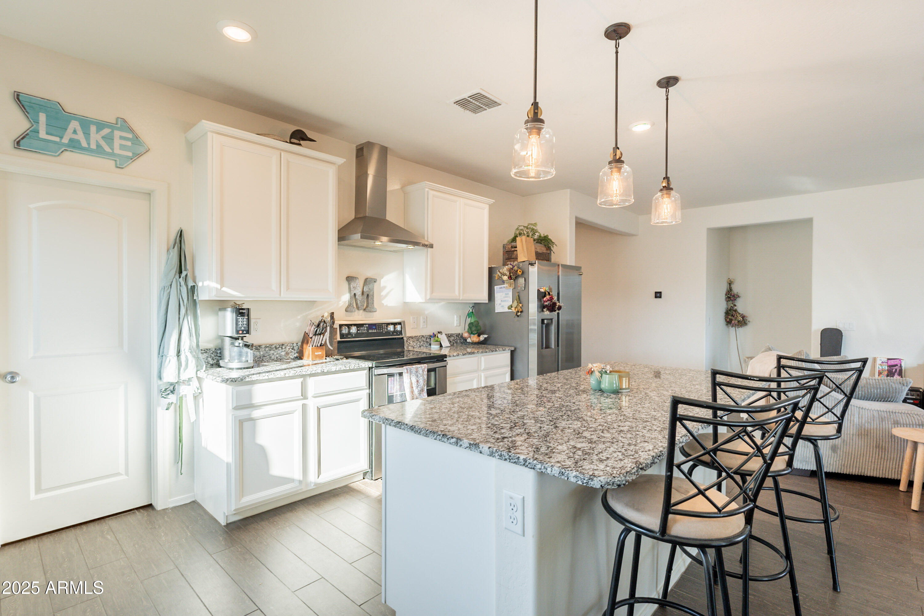 1813 Grenadine Road Phoenix, AZ 85040 - Photo 10 of 33 a kitchen with stainless steel appliances granite countertop a kitchen island a stove a table and chairs