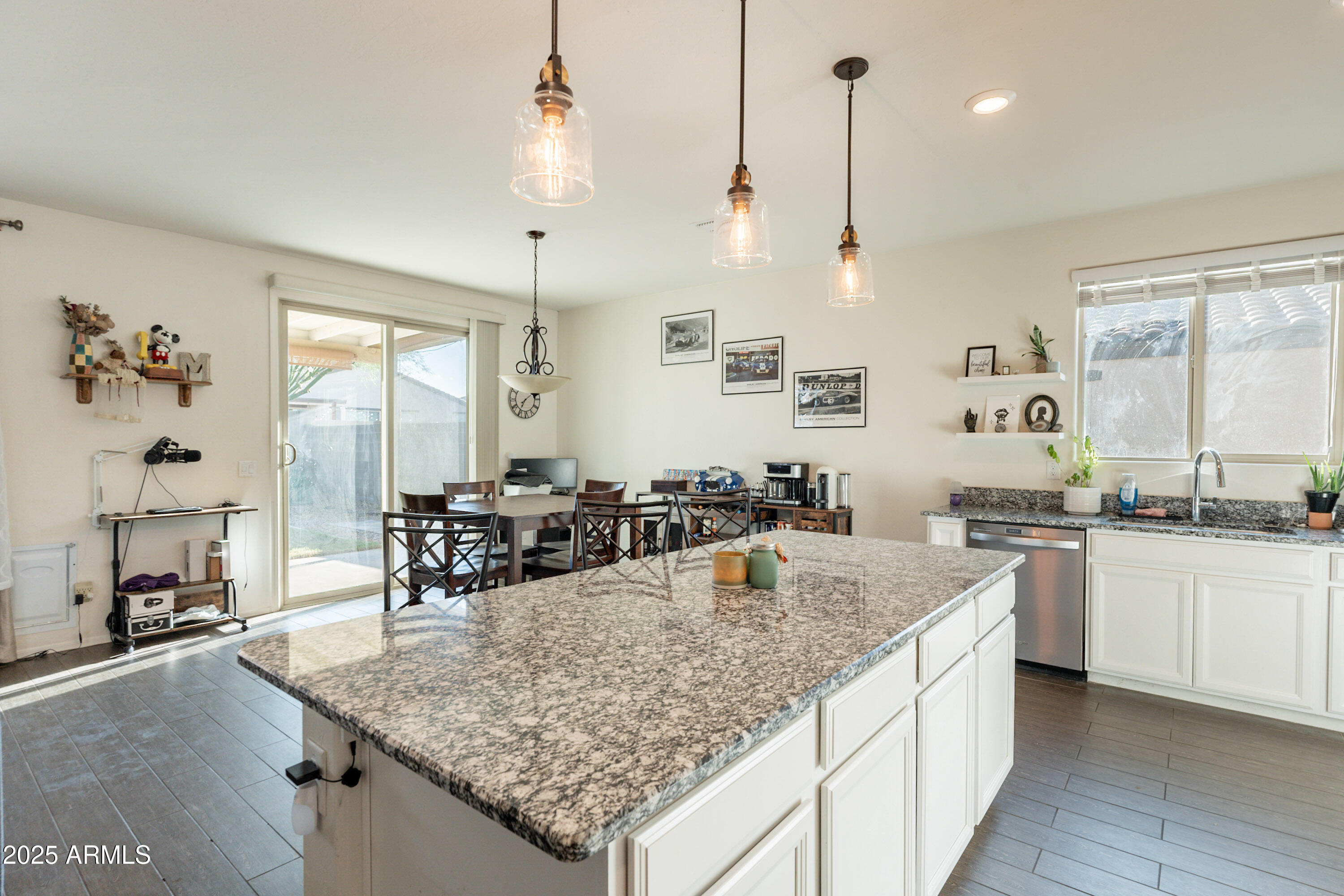 1813 Grenadine Road Phoenix, AZ 85040 - Photo 12 of 33 a kitchen with granite countertop a sink a stove and chairs