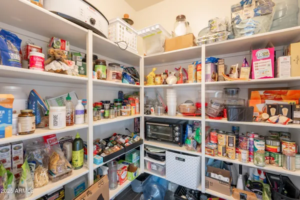 a kitchen with stainless steel appliances granite countertop wooden cabinets a stove a sink a dining table and chairs