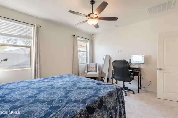 a bedroom that has a bed and a chair in it