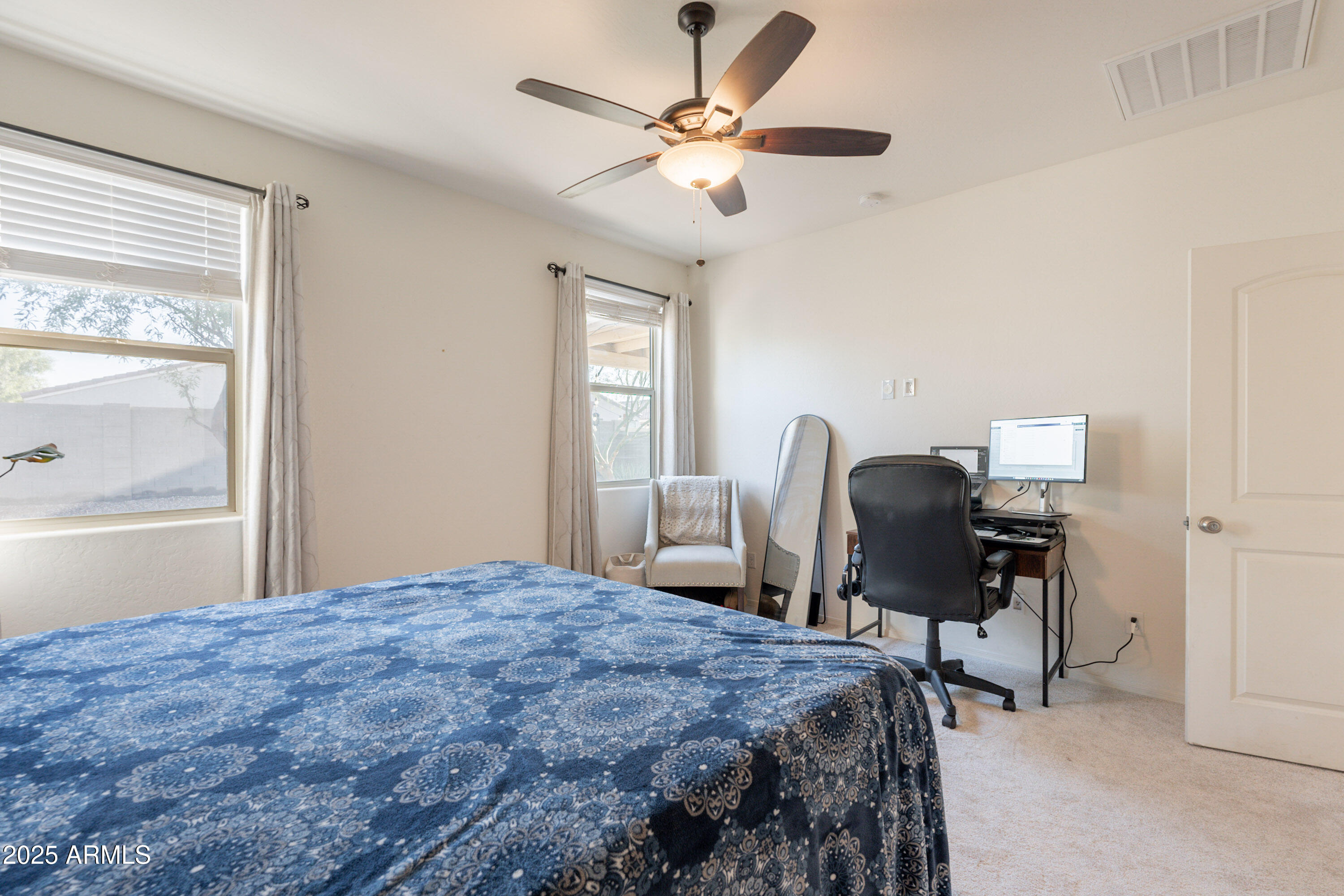 1813 Grenadine Road Phoenix, AZ 85040 - Photo 18 of 33 a bedroom that has a bed and a chair in it