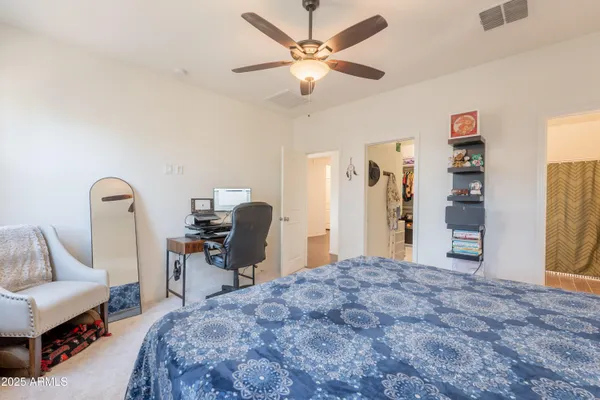 a bedroom with a bed a desk and chair