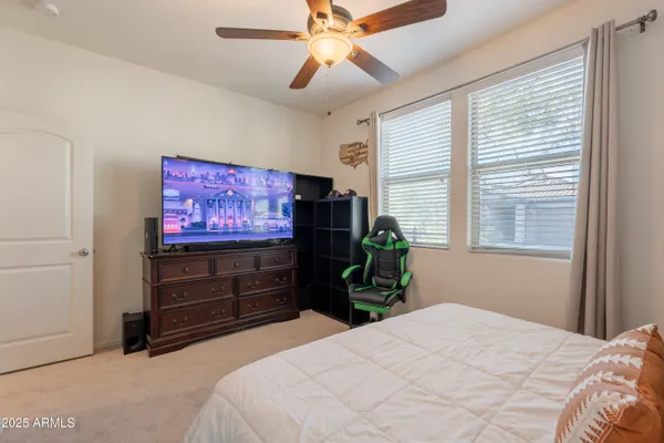 a bedroom with a bed and a flat screen tv