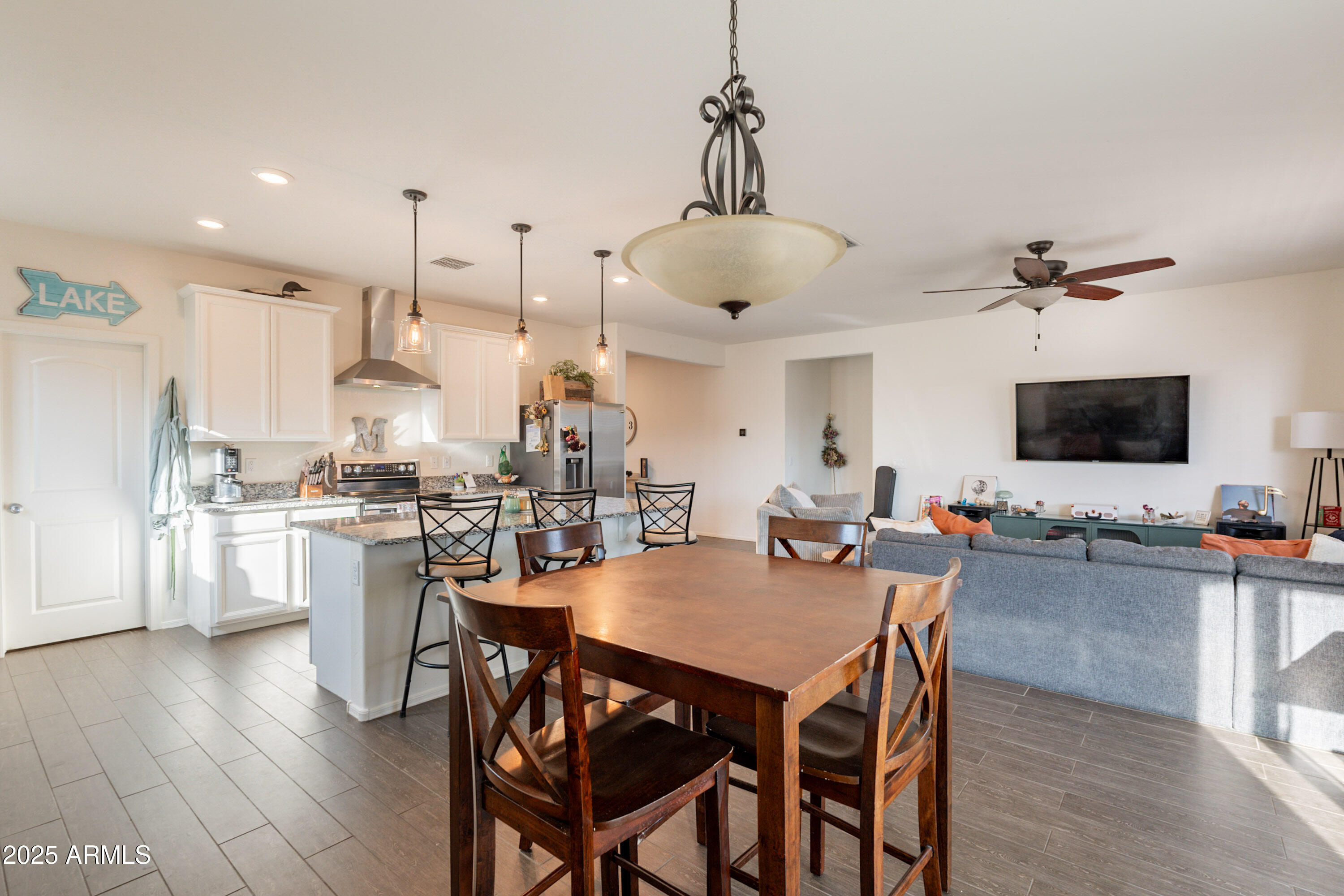 1813 Grenadine Road Phoenix, AZ 85040 - Photo 8 of 33 a view of a dining room and livingroom with furniture wooden floor a chandelier