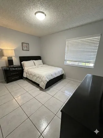 a bathroom with a toilet sink and shower