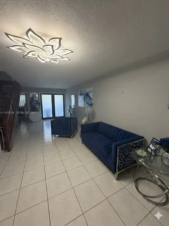 a living room with furniture a air conditioner and a dining table
