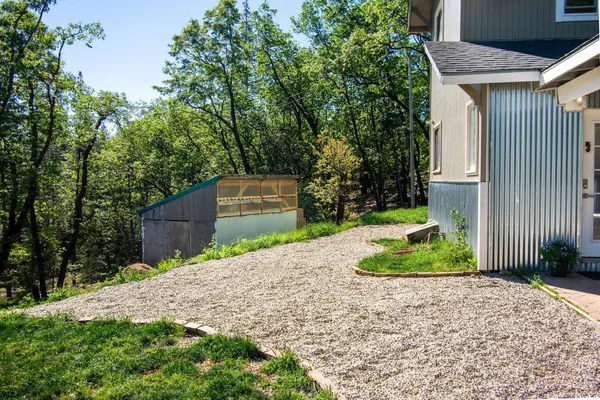 a pathway of a house with a yard