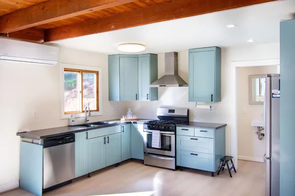 a kitchen with a sink a stove and cabinets