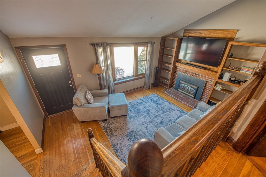 12 Brewster Road Randolph, MA 02368 - Photo 4 of 27 a living room with furniture and a fireplace