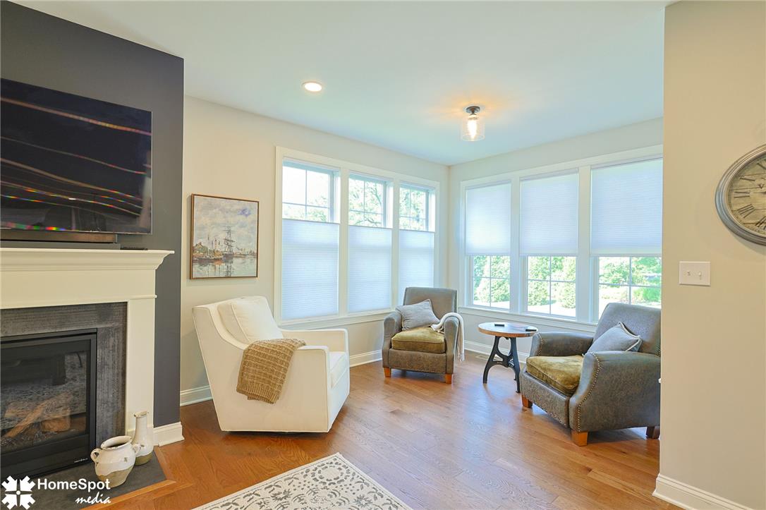 4518 Old Saucon Road Bethlehem, PA 18015 - Photo 8 of 25 A welcoming living area showcases rich wood flooring and a classic fireplace, illuminated by ample natural light.