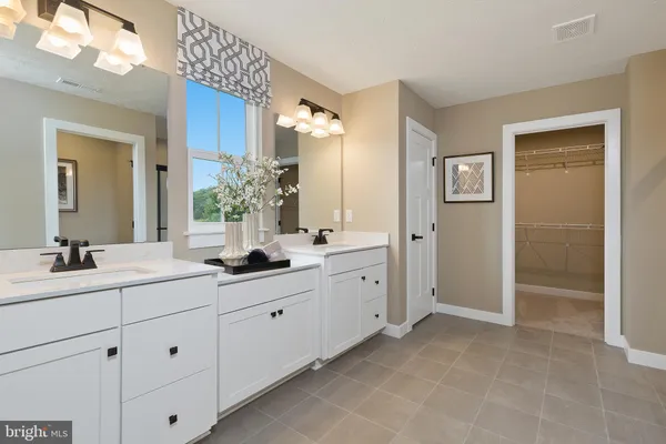 a bathroom with double sink and a mirror