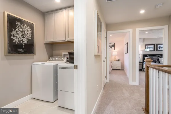 a view of a kitchen with fridge and wooden floor