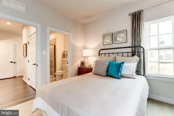 a bedroom with a large bed and a window