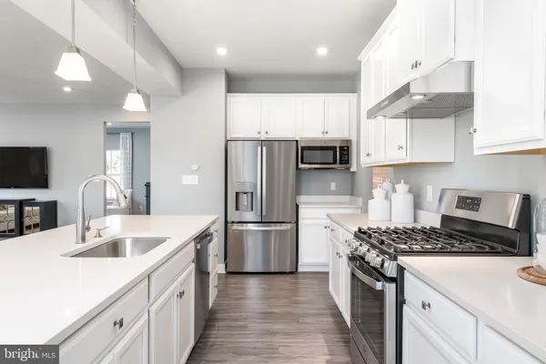 a kitchen with a sink stove and refrigerator