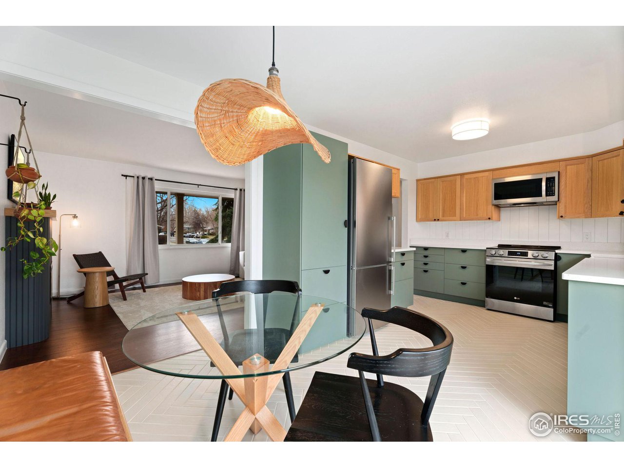 2600 Avocet Road Fort Collins, CO 80526 - Photo 6 of 26 Eat-in kitchen with custom bench and lighting. Soft-close cabinetry throughout, quartz countertops, herringbone tile floors, stainless steel appliances.